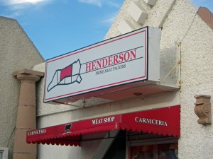 Henderson Meats' sign is recognizable by the meat diagram.