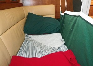 Underway our settee berth provides a secure place to sleep and a view of the nav station.