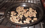 Toasting walnuts for moroccan style lamb tacos.