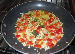 The onions and peppers are sweated in olive oil.