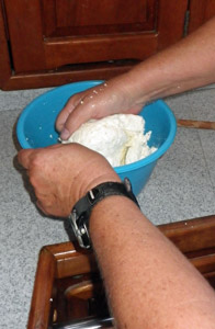 The mozzarella is kneaded to smooth the texture.